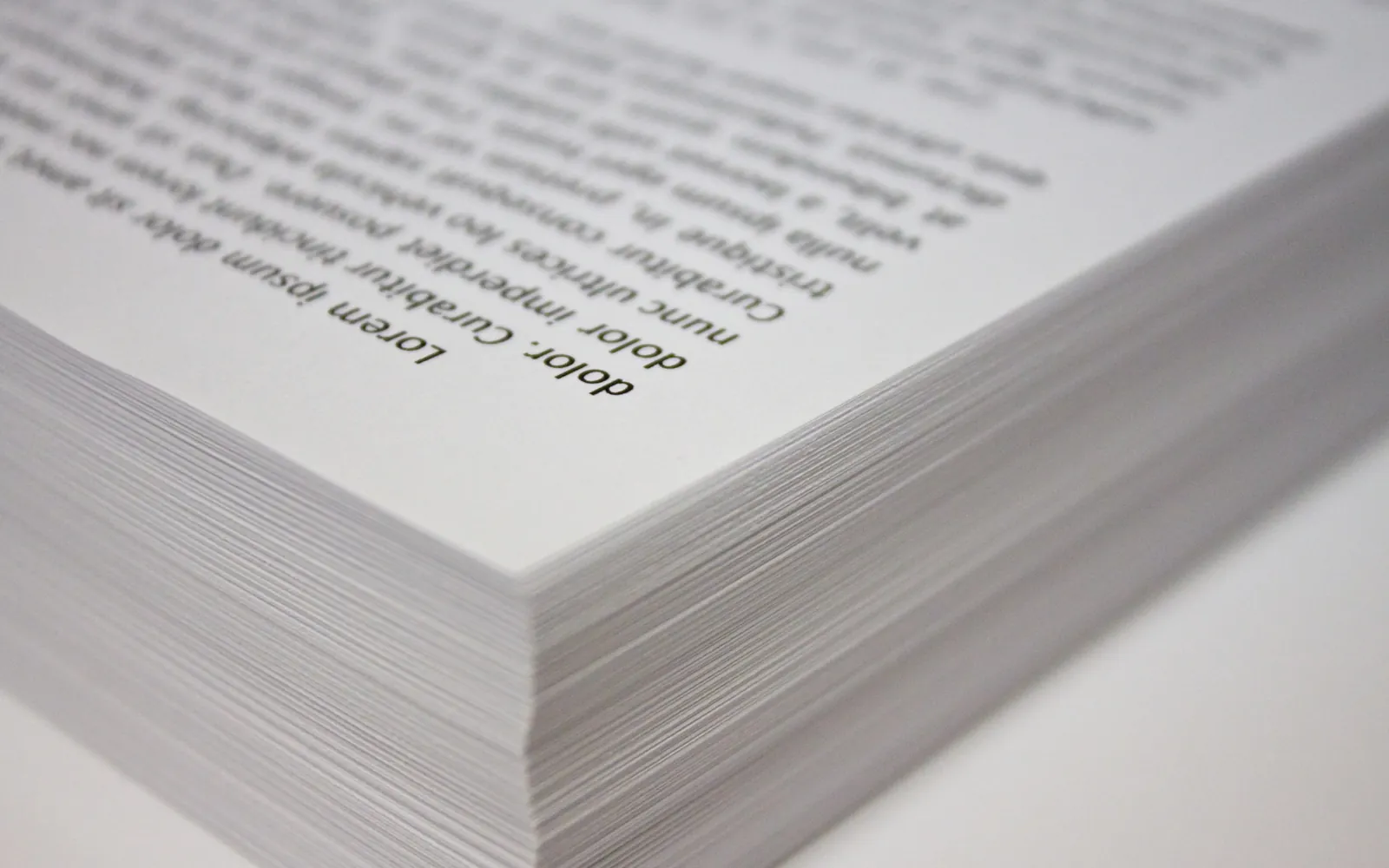 A stack of white copy paper sheets seen from the side