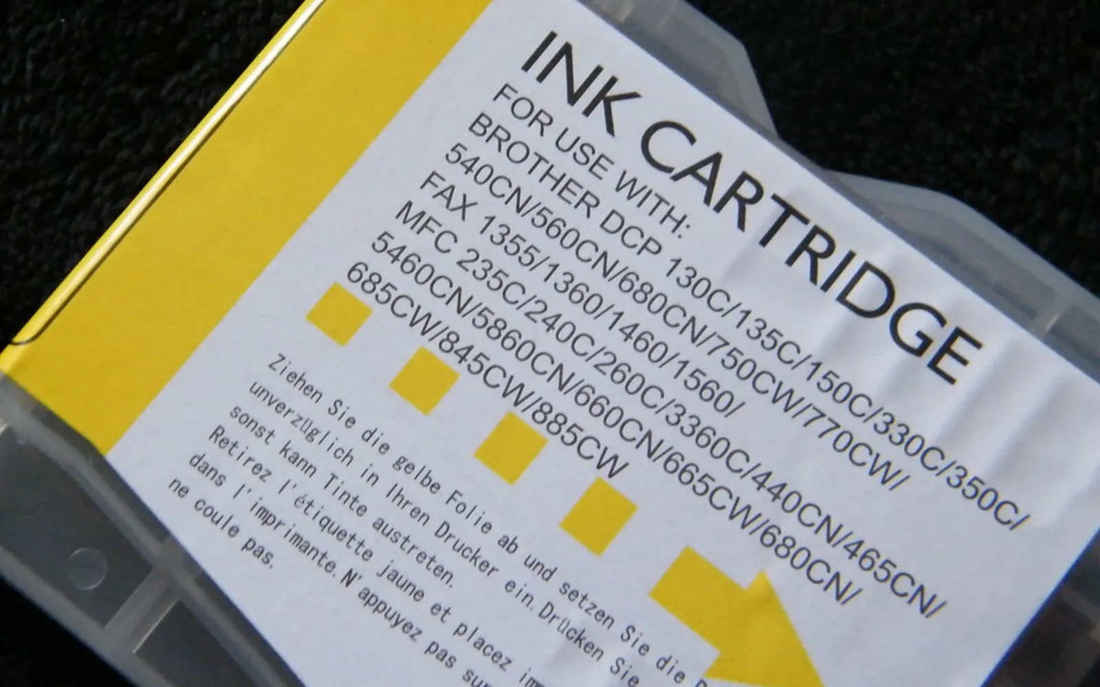 A single yellow inkjet cartridge on a plain background